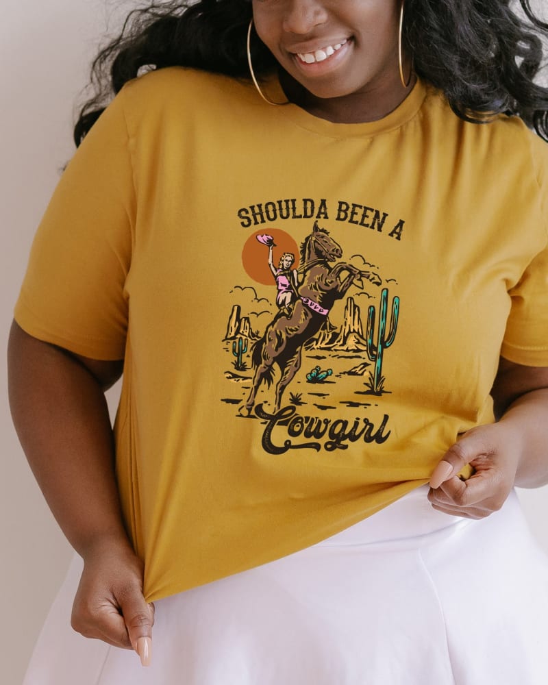 Front of a model wearing a size XL Shoulda Been A Cowgirl in Mustard by Simply Sage Market. | dia_product_style_image_id:281567